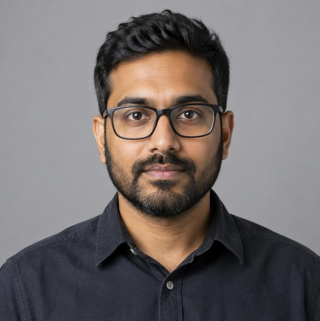 Studio portrait of a man video editor with glasses